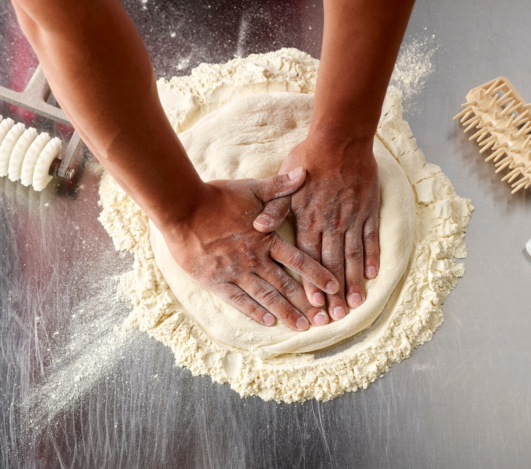 Papa Johns team members rolling dough