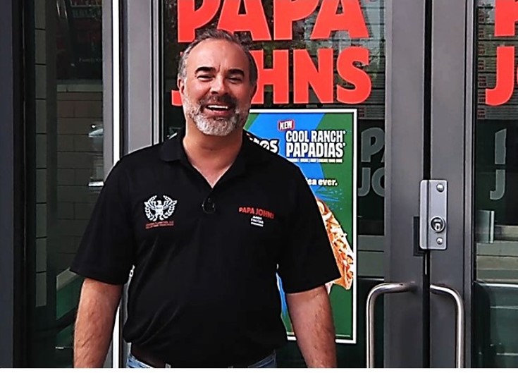 Andy Freitas standing outside one of his Papa Johns restaurants.