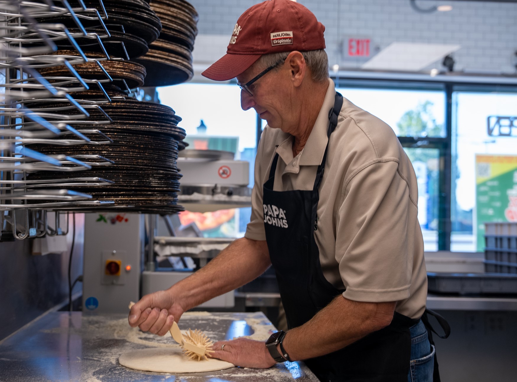 Todd Penegor prepares a pizza at a Papa Johns restaurant