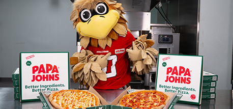 Freddie Falcon poses with Papa Johns pizzas.