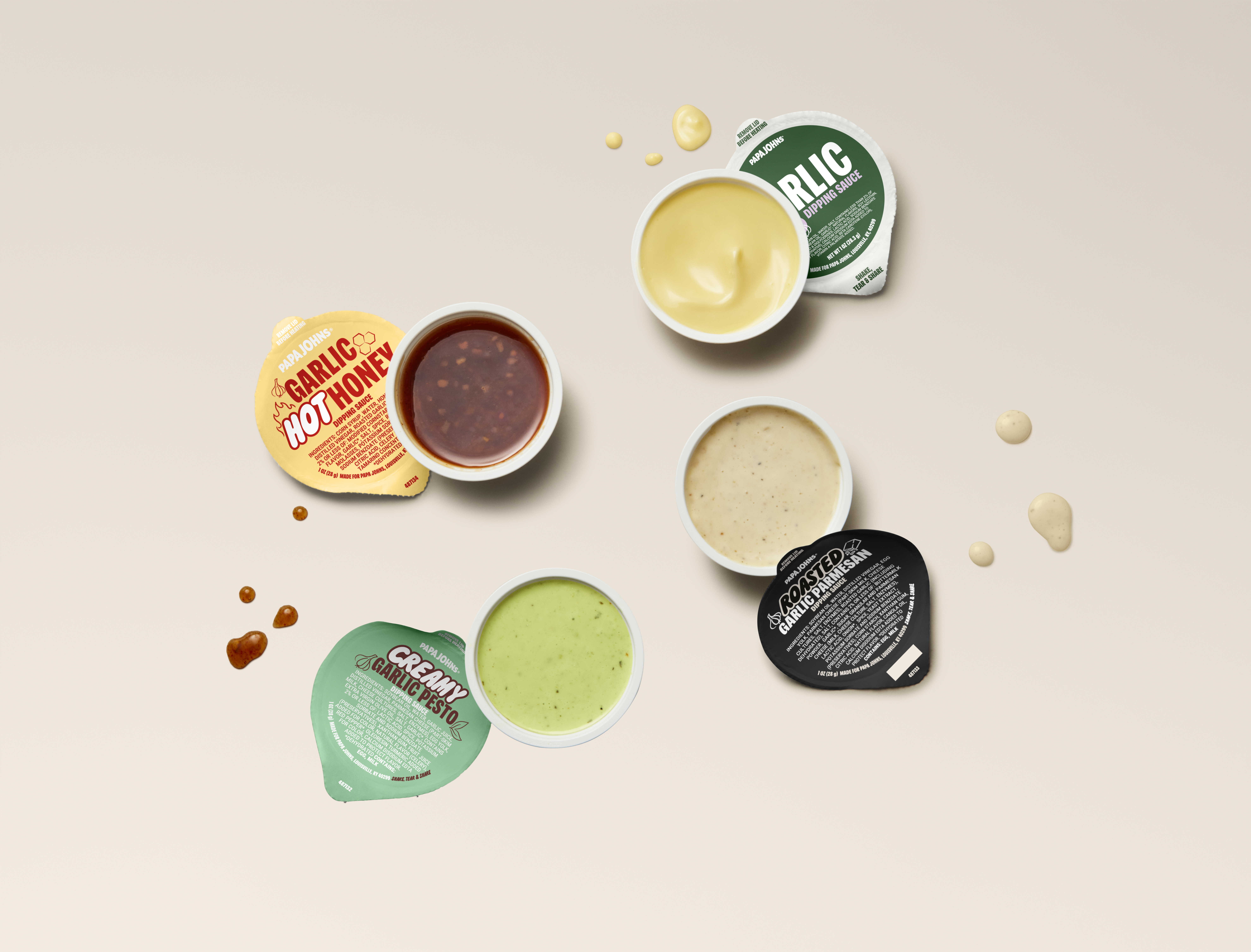 Four garlic dips set on a table