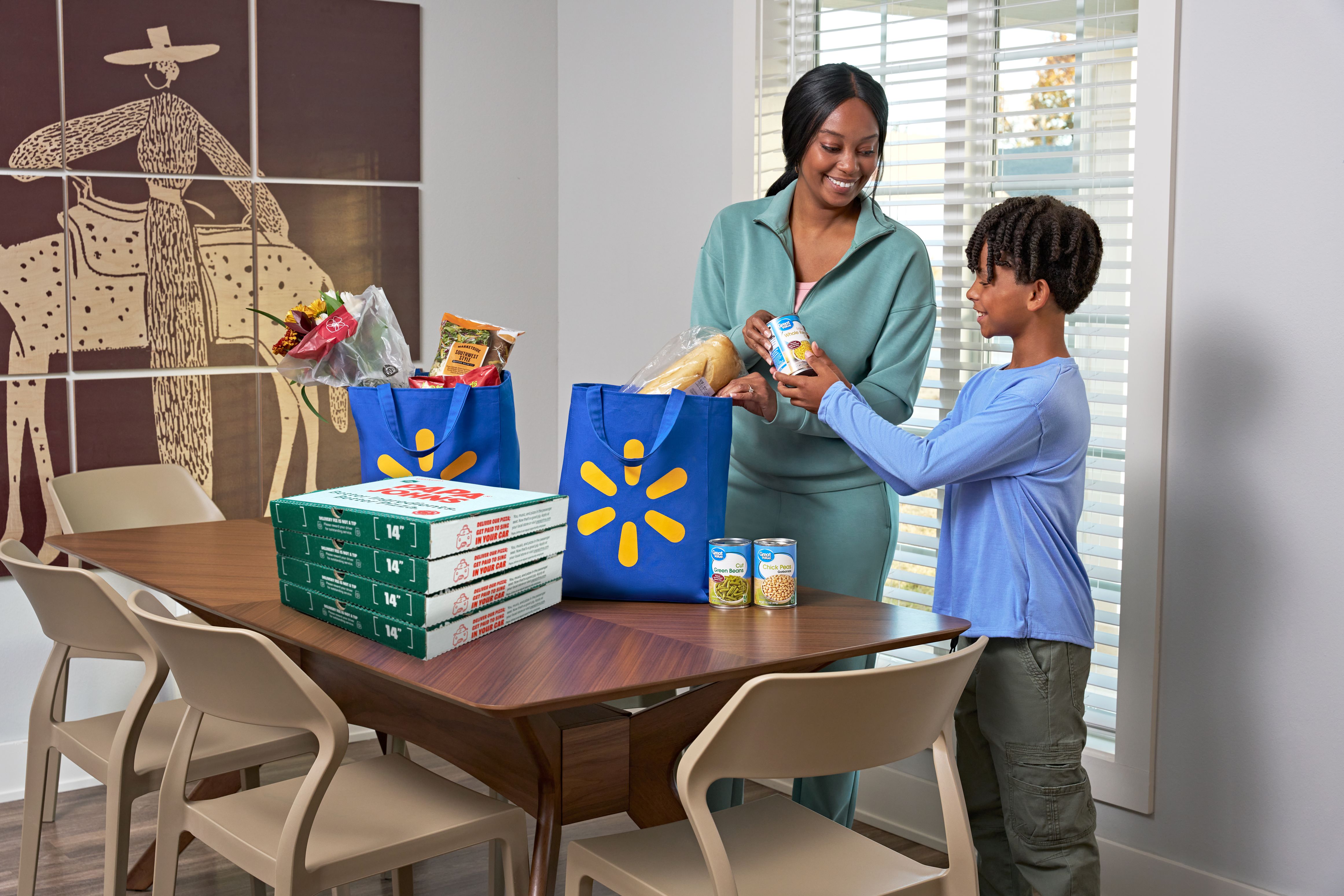 A mom and son receive a delivery of Papa Johns pizza from Walmart Express Delivery