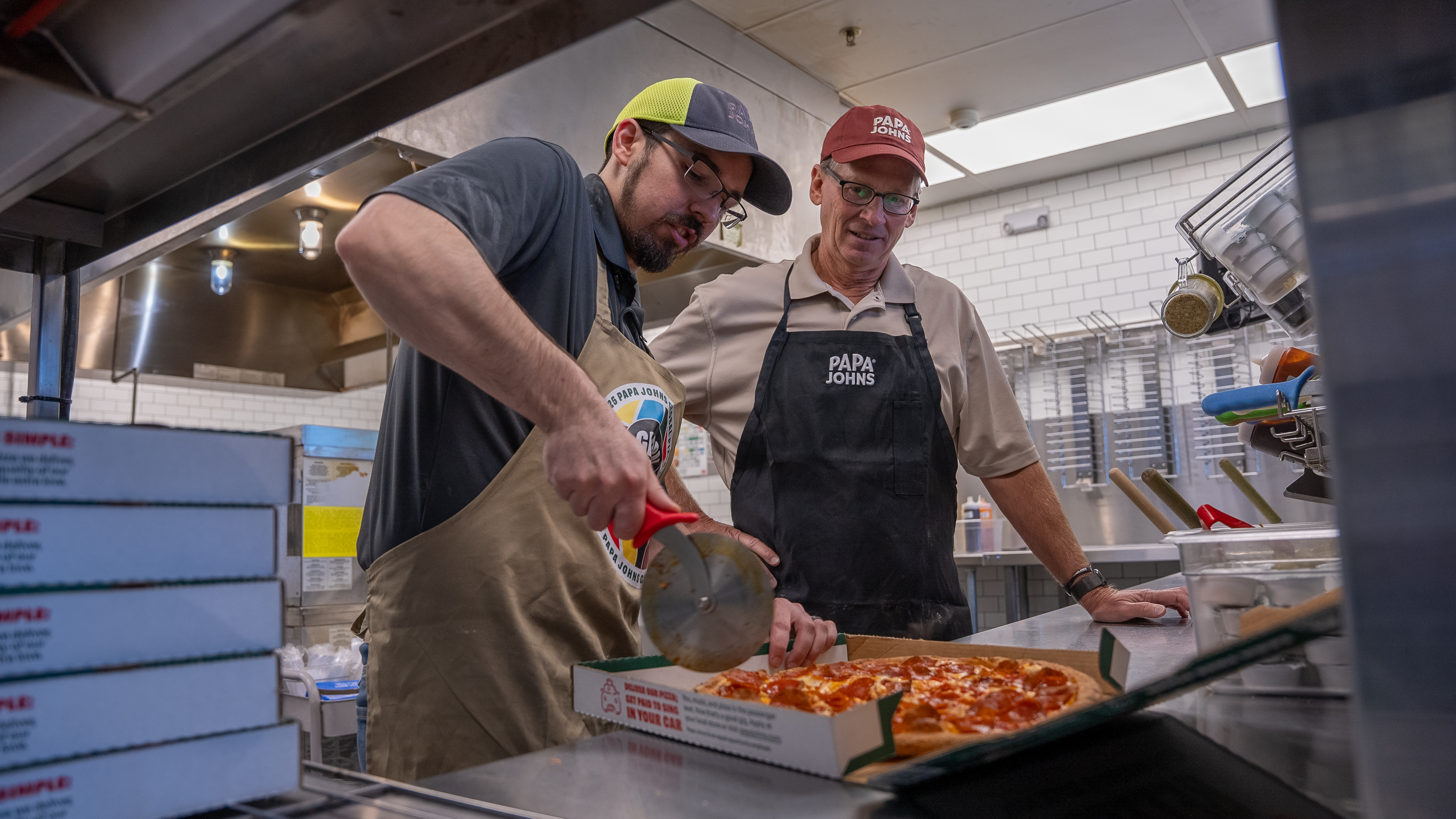 Todd assists Papa Johns team members