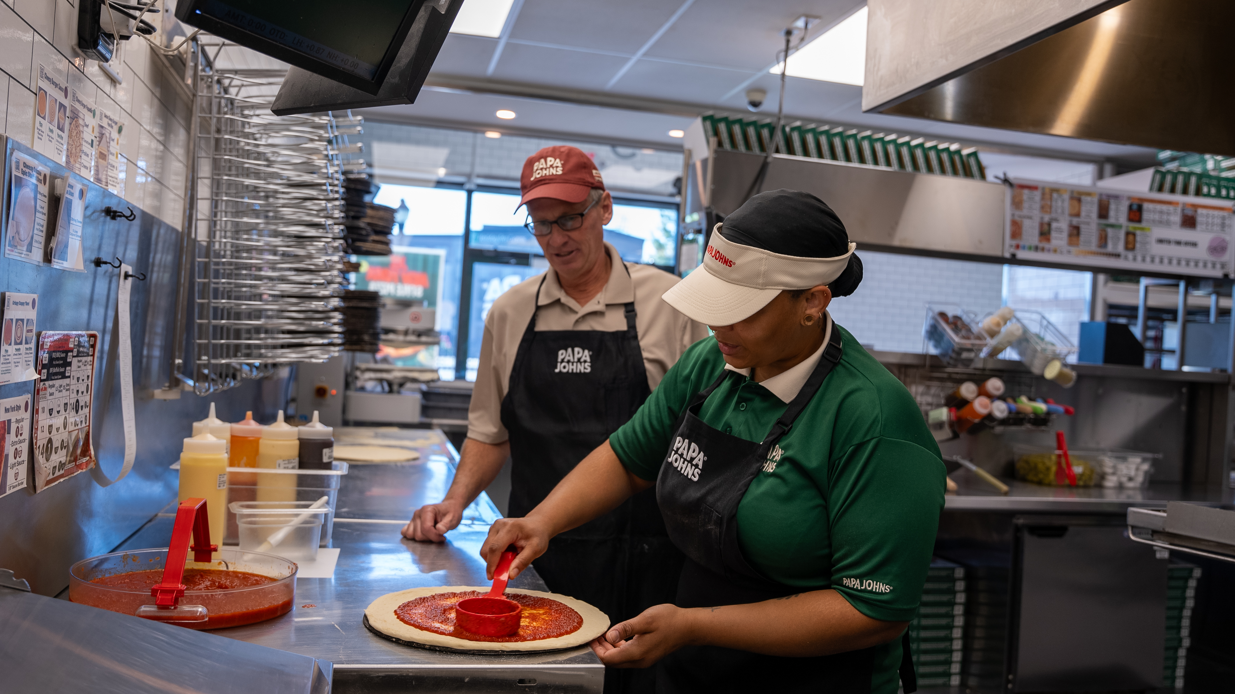 Todd assists Papa Johns team members