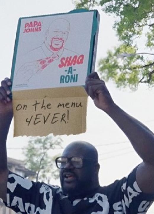 Shaquille O'Neal holding a Shaq-a-Roni box