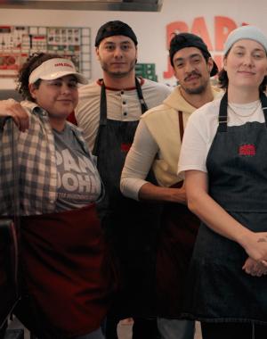 A group of team members inside a Papa Johns restaurant