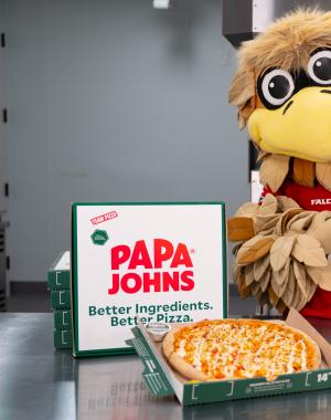 Freddie Falcon poses with Papa Johns pizzas.