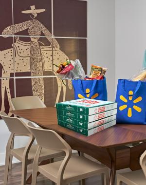 A mom and son receive a delivery of Papa Johns pizza from Walmart Express Delivery