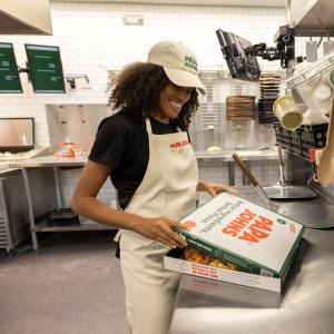 Team member boxing pizza