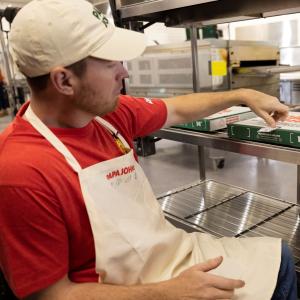 Papa Johns team member conducting quality check