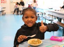 Young girl happily eating