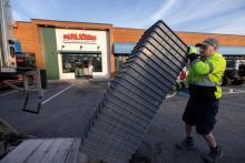 A man unloading trays outside a Papa Johns restaurant