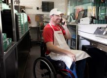 Papa Johns team member assisting customer on phone