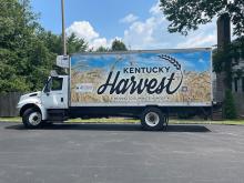 A truck with a sign that reads "Kentucky Harvest" 