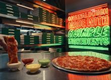 Pizza being dipped into garlic dip