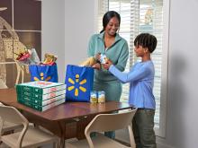 A mom and son receive a delivery of Papa Johns pizza from Walmart Express Delivery