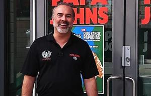 Andy Freitas standing outside one of his Papa Johns restaurants.