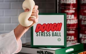 A hand squishing a dough stress ball