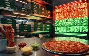 Pizza being dipped into garlic dip