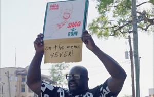 Shaquille O'Neal holding a Shaq-a-Roni box