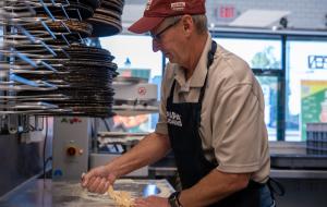 Todd Penegor prepares a pizza at a Papa Johns restaurant