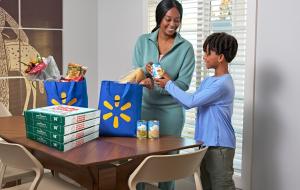 A mom and son receive a delivery of Papa Johns pizza from Walmart Express Delivery