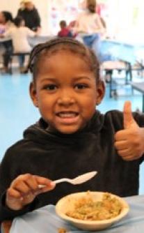 Young girl happily eating