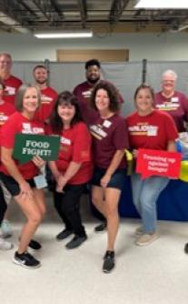 Louisville team members participate in Dare to Care’s National "Food Fight" Volunteer Day 