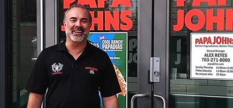 Andy Freitas standing outside one of his Papa Johns restaurants.