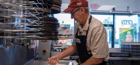 Todd Penegor prepares a pizza at a Papa Johns restaurant