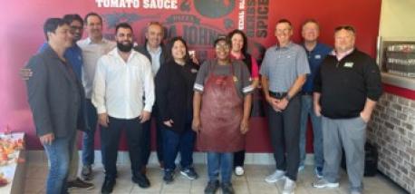 Todd Penegor meets with team members at a Papa Johns restaurant