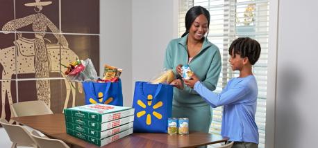A mom and son receive a delivery of Papa Johns pizza from Walmart Express Delivery