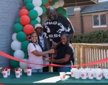 Shaq and local youths cut the ribbon at new Papa Johns restaurant
